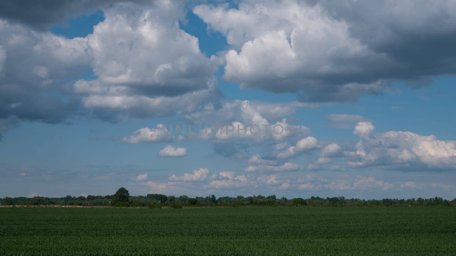 A green vast valley and a cloudy sky during dusk