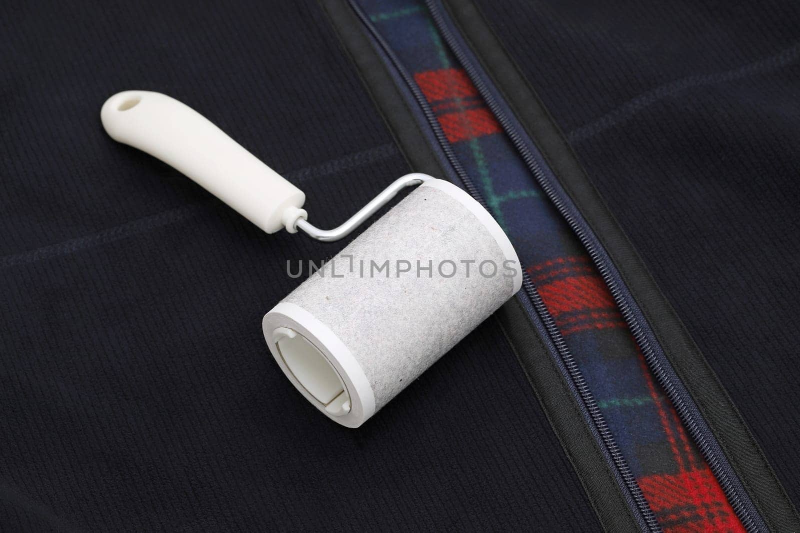 close up of used sticky roller cleaning, housework and housekeeping concept