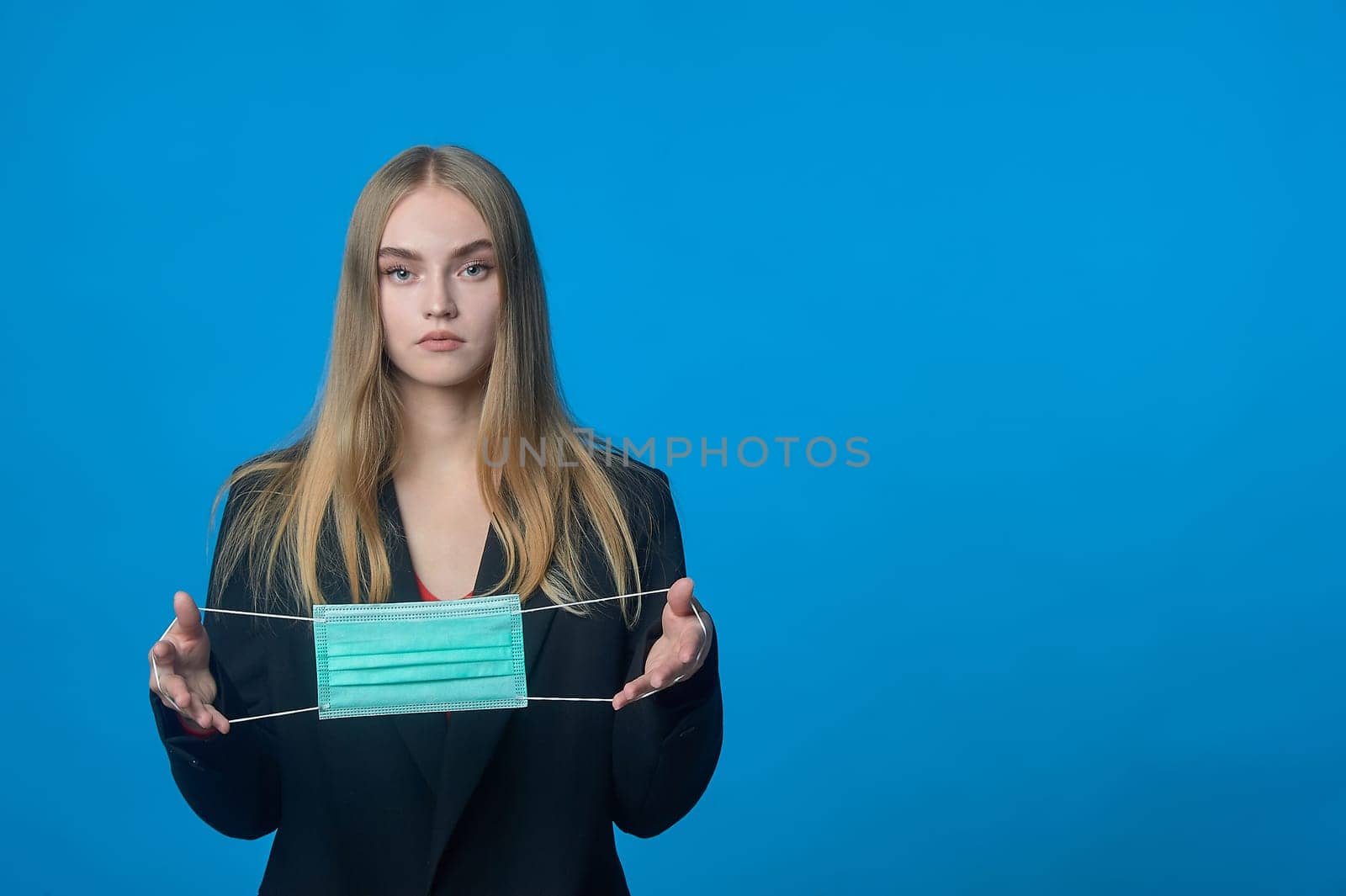 Girl with a medical mask in her hands. High quality photo