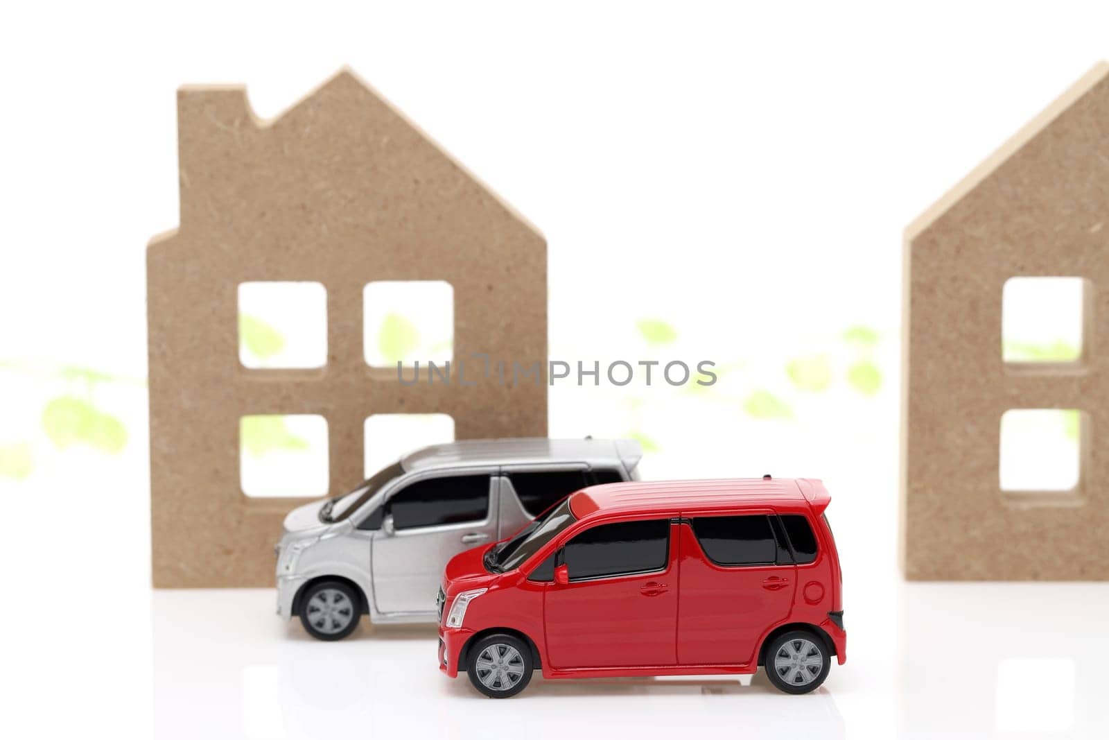 Wooden toy house and toy car isolated on white background