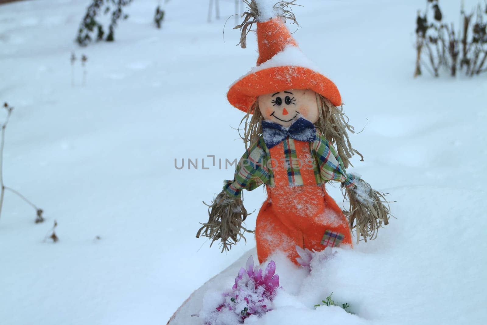 scarecrow on a field covered with deep snow winter landscape