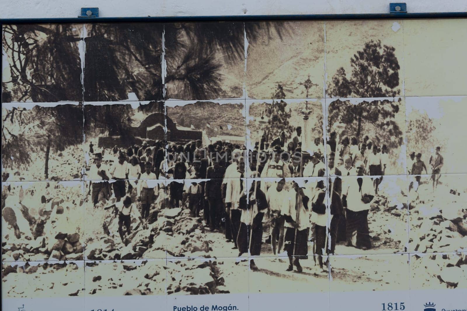 CRAN CANARIA, MOGAN - NOVEMBER 15, 2019:.Old photo on a wall tile on a house in Mogan. Picture shows the old town of Mogan, Gran Canaria, Spain