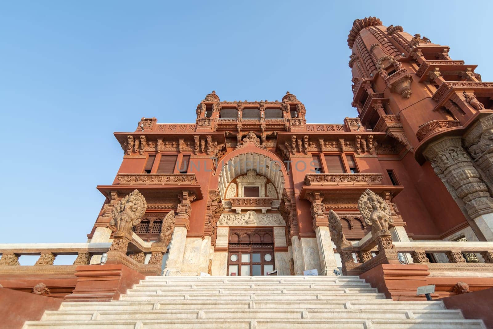 Low angle view of front facade of Baron Empain Palace, a historic mansion inspired by the Cambodian Hindu temple of Angkor Wat, located in Heliopolis district, Cairo, Egypt
