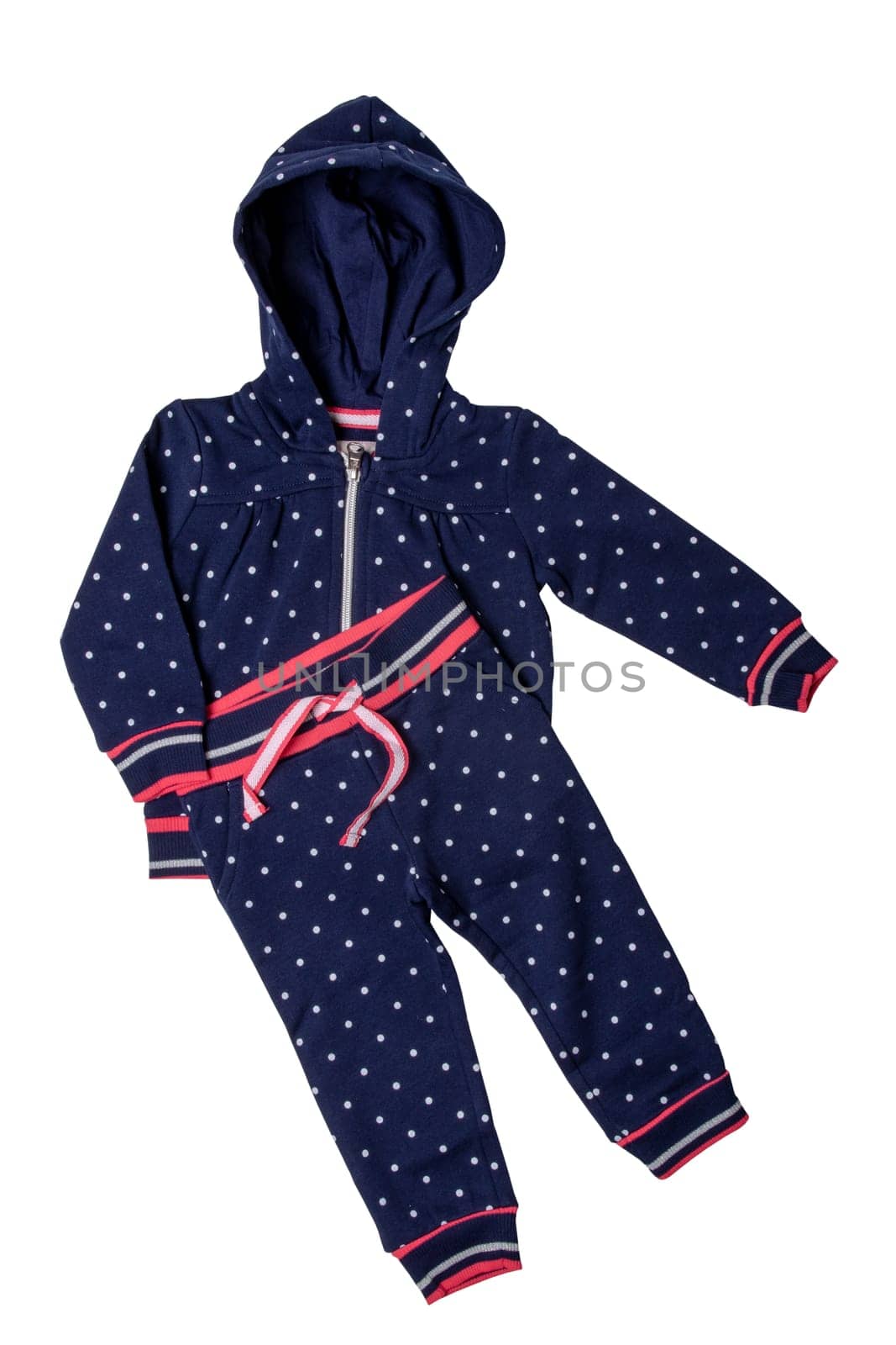 Closeup of a stylish fashionable dark blue hooded sweater with polka dots and a denim pants for the little girl. Children sport trousers and jacket with hood. Clipping path.