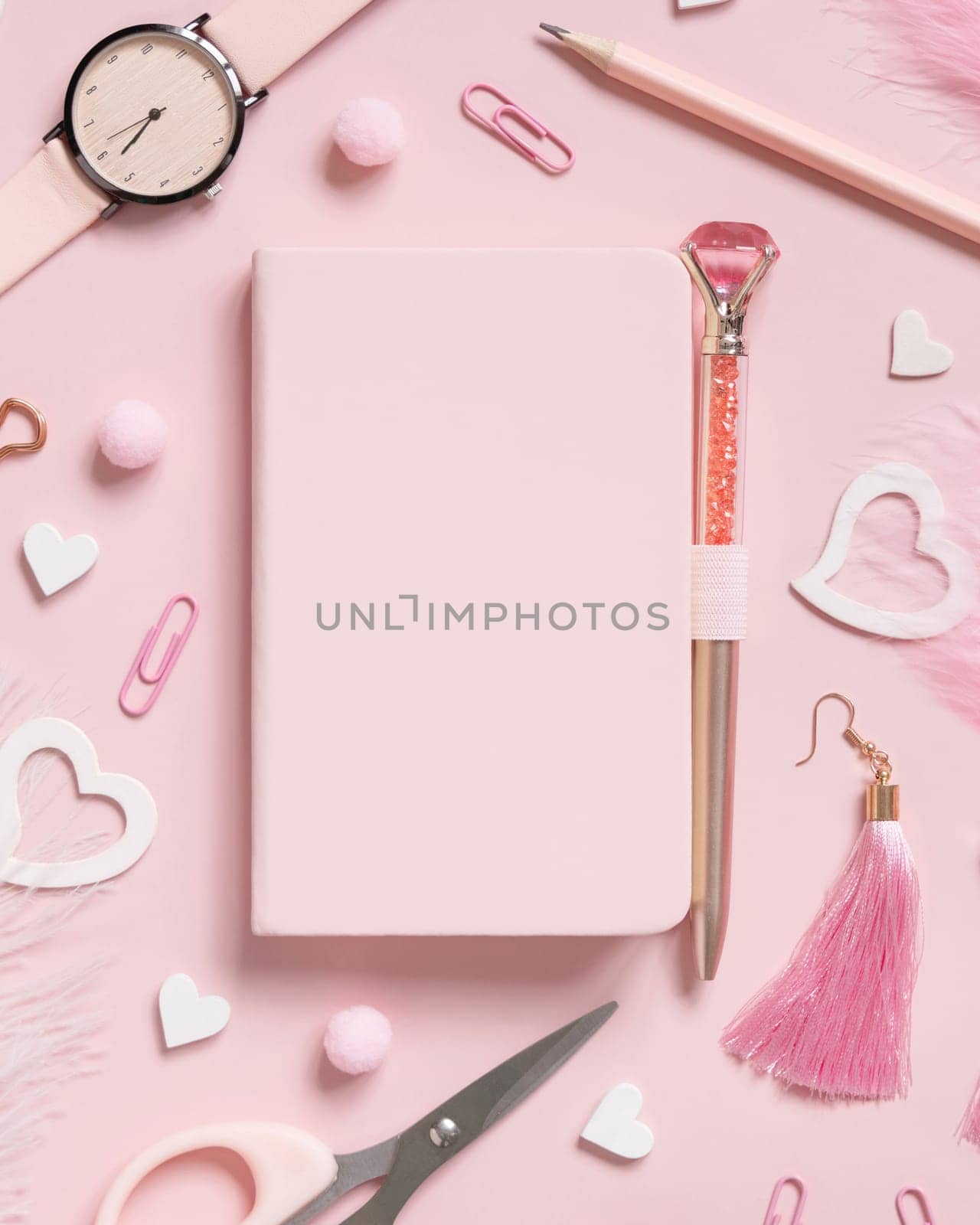 Hardcover notebook, Pink school accessories and hearts on light pink, Top view, textbook mockup. Girly workplace with notebook, scissors, pencil, pen, paperclips, earrings and watch. Back to school