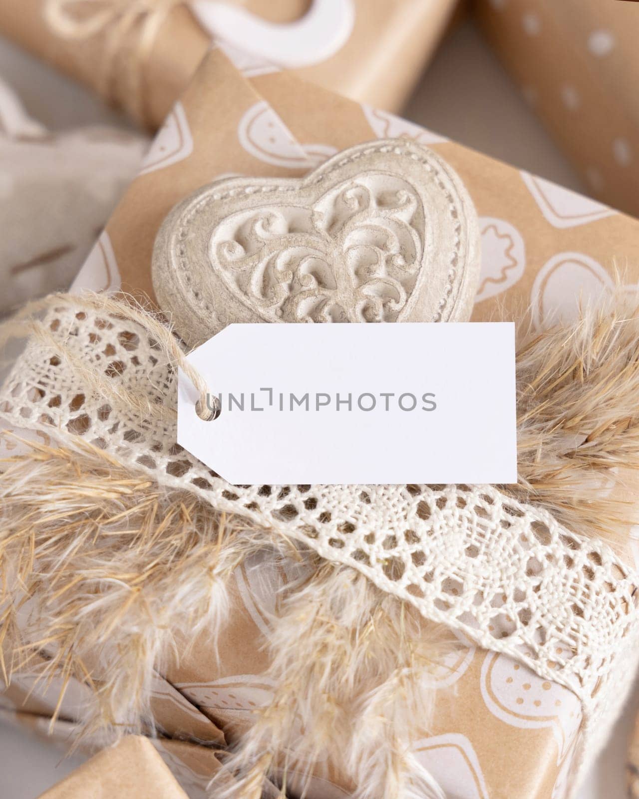 Valentines present with horizontal gift tag, heart and pampas grass close up. Spring scene with blank label. Rustic, cottage chic or bohemian mockup, copy space
