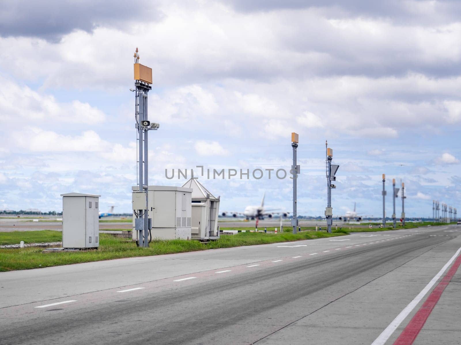 The planes are parked at the airport, close to the road and pold