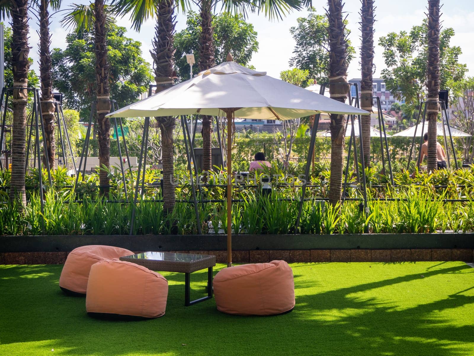 Many colorful bean bag seats to relax on grass outdoors. A convenient place to relax, a company or for one.