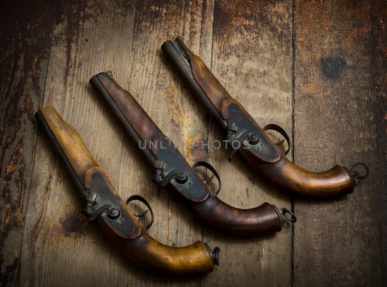 Vintage pistols on wooden background