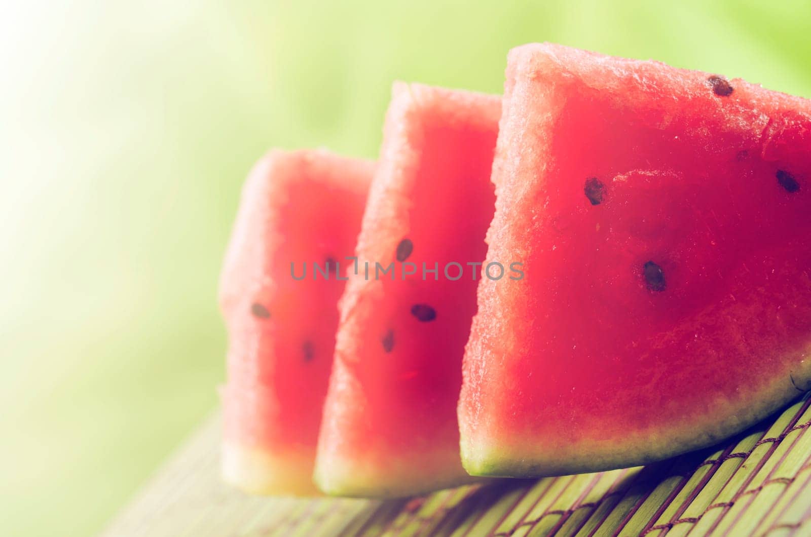 Watermelon slices on green background