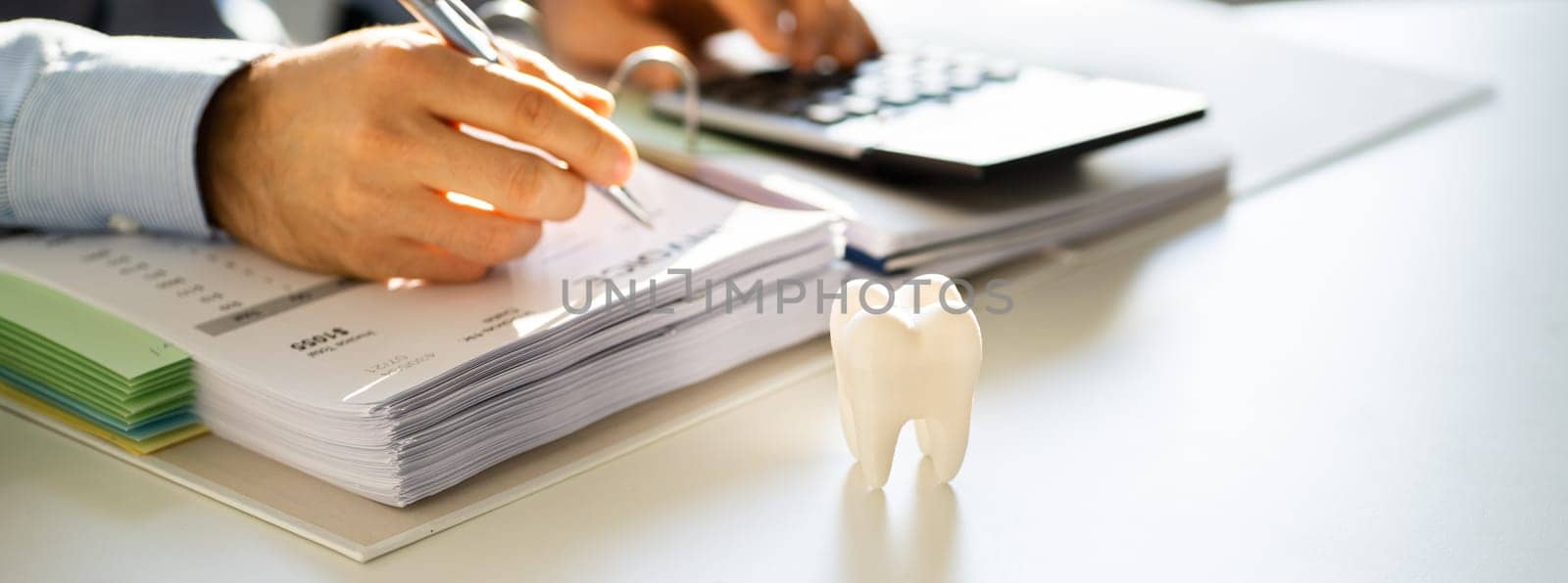 Dentist Bill And Tax Paperwork At Desk