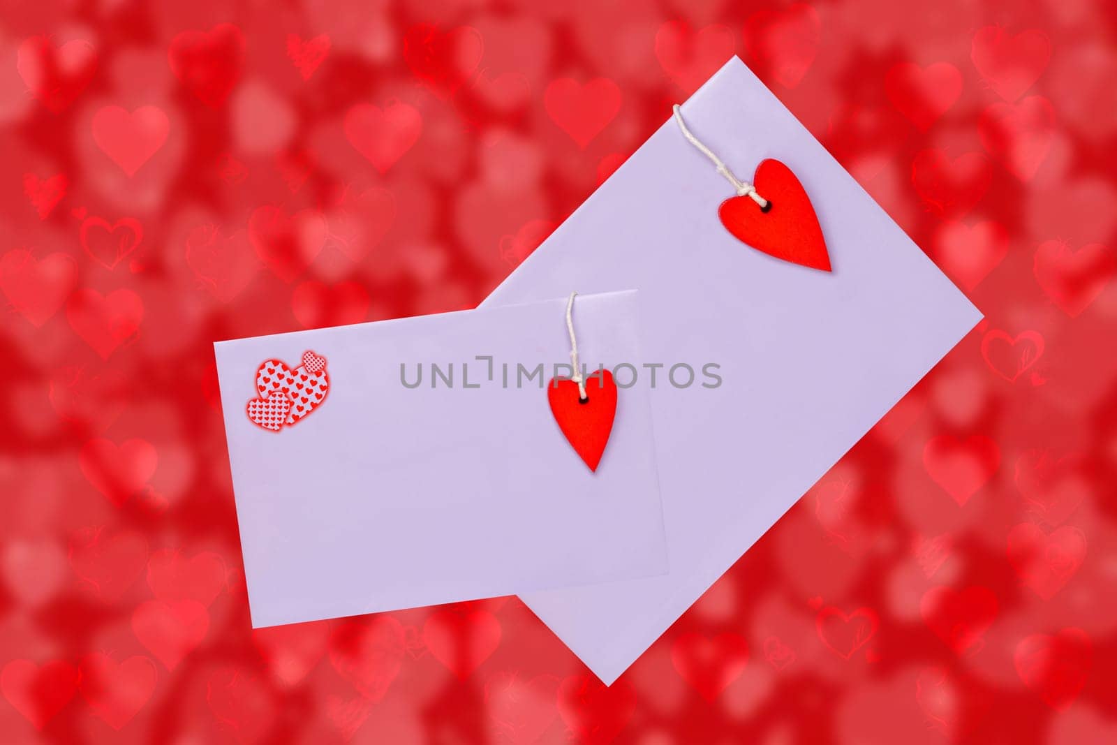 Happy Valentine or Mothers Day card template. 3D illustration of two envelopes with red hearts made of wood over abstract red background with hearts. Space for text design.