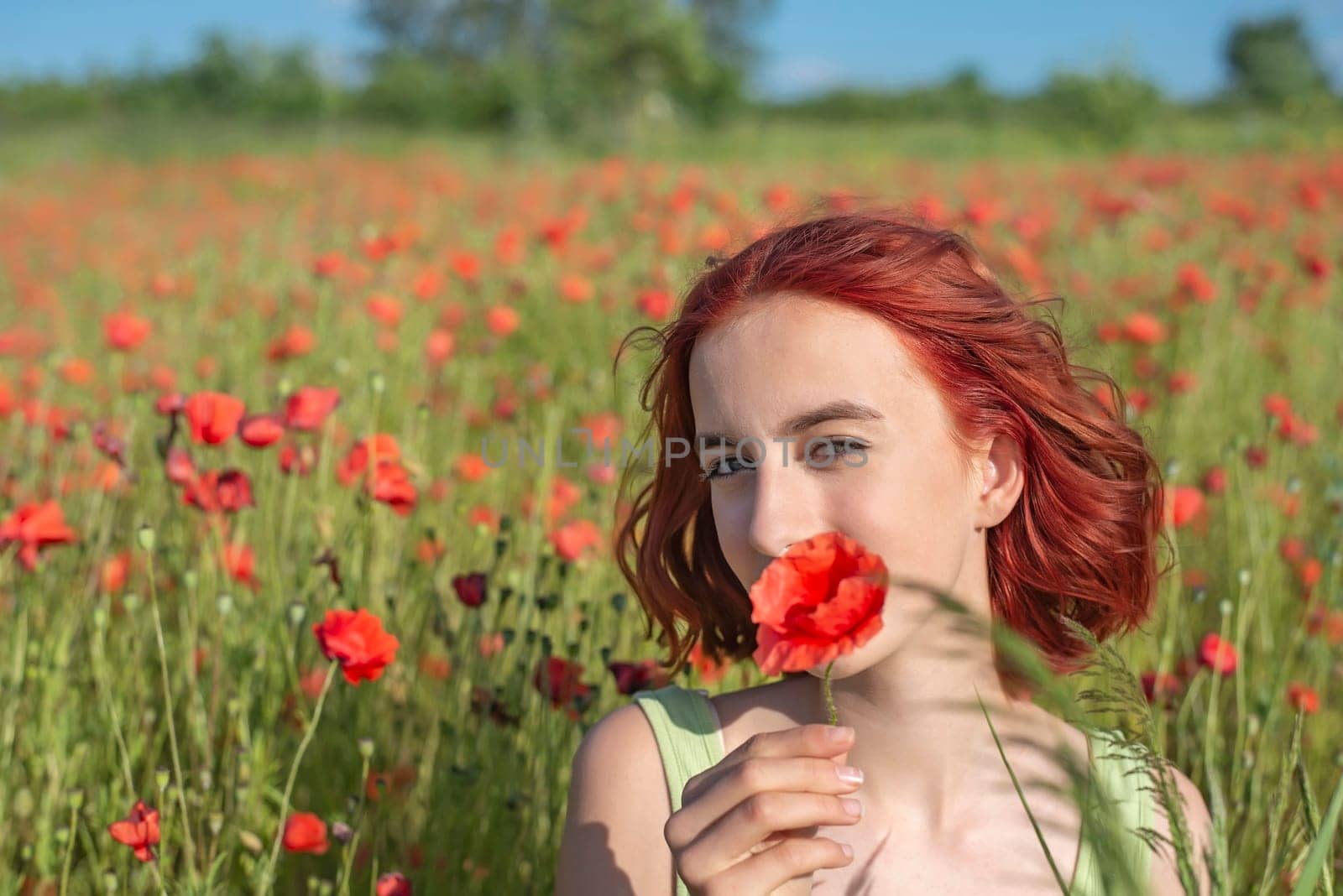 girl with poppy flower in poppy field