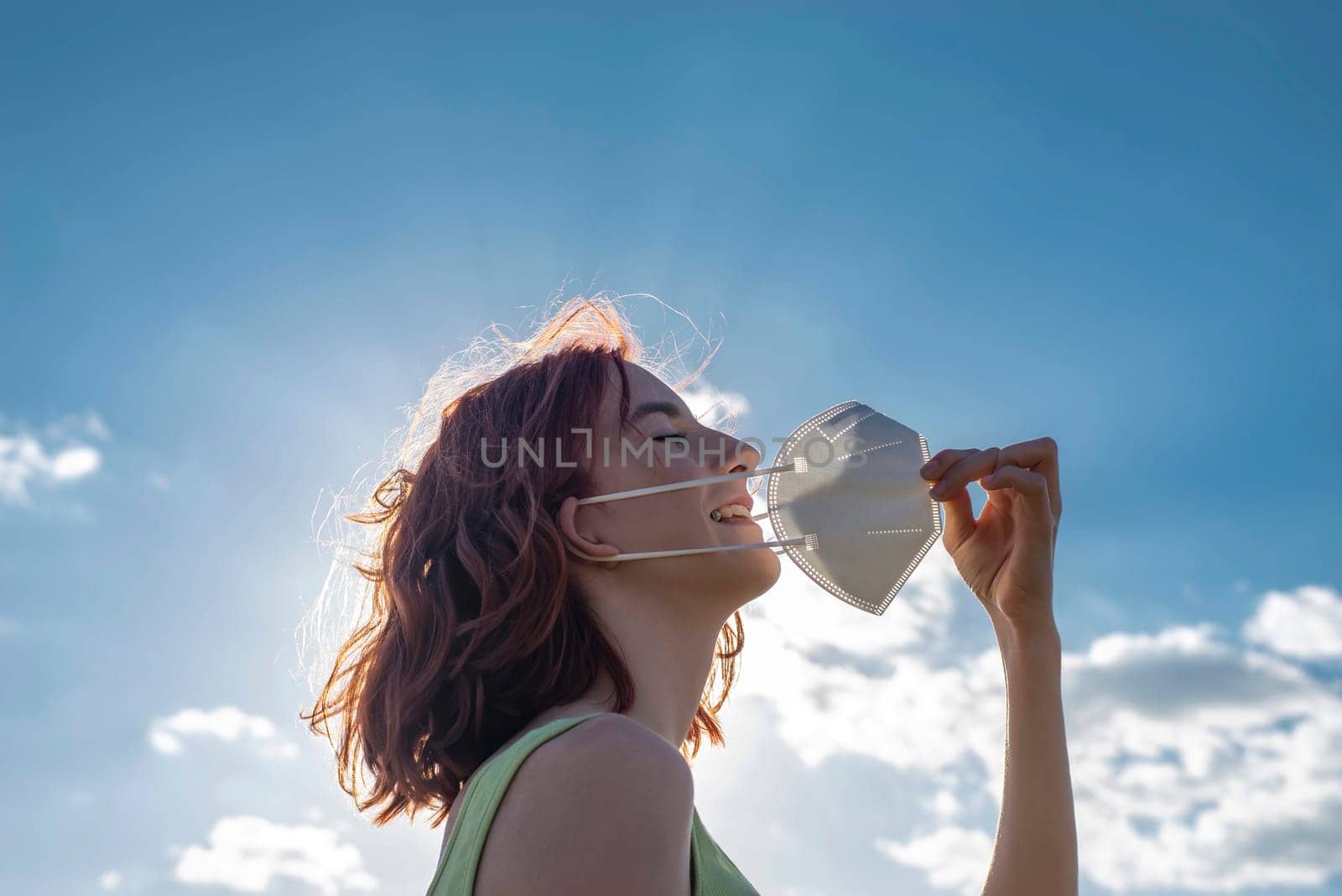 girl taking off protection mask