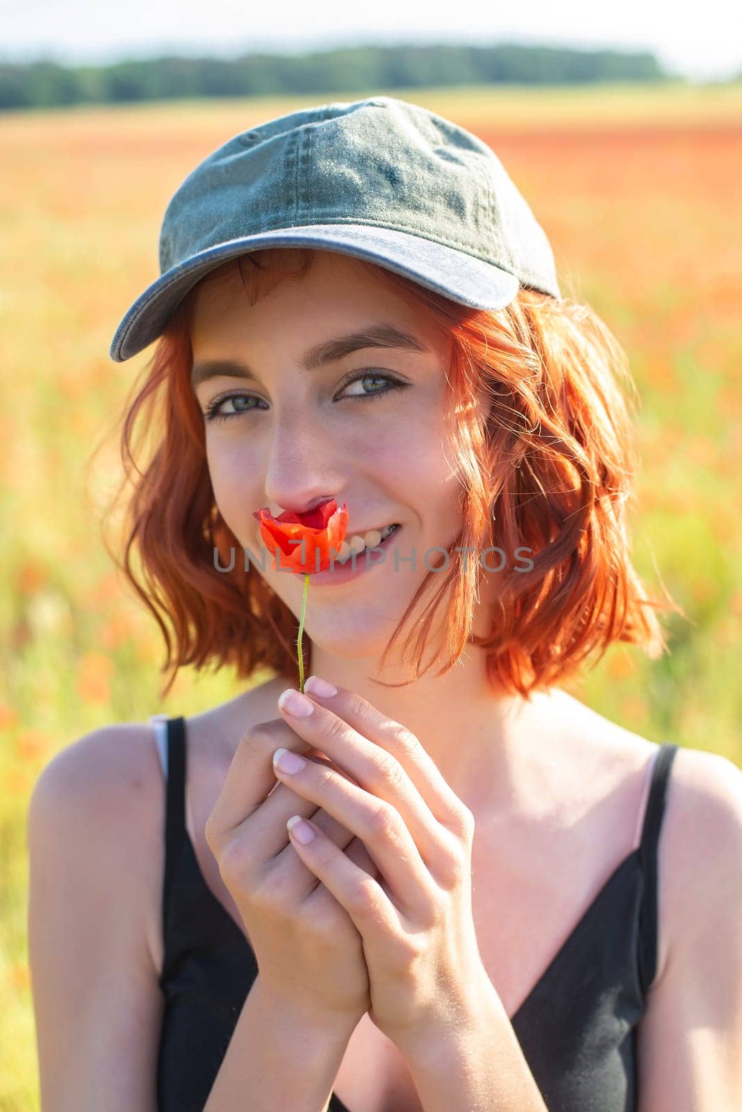 girl with poppy flower in poppy field