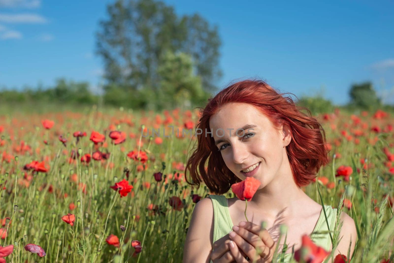 girl with poppy flower in poppy field