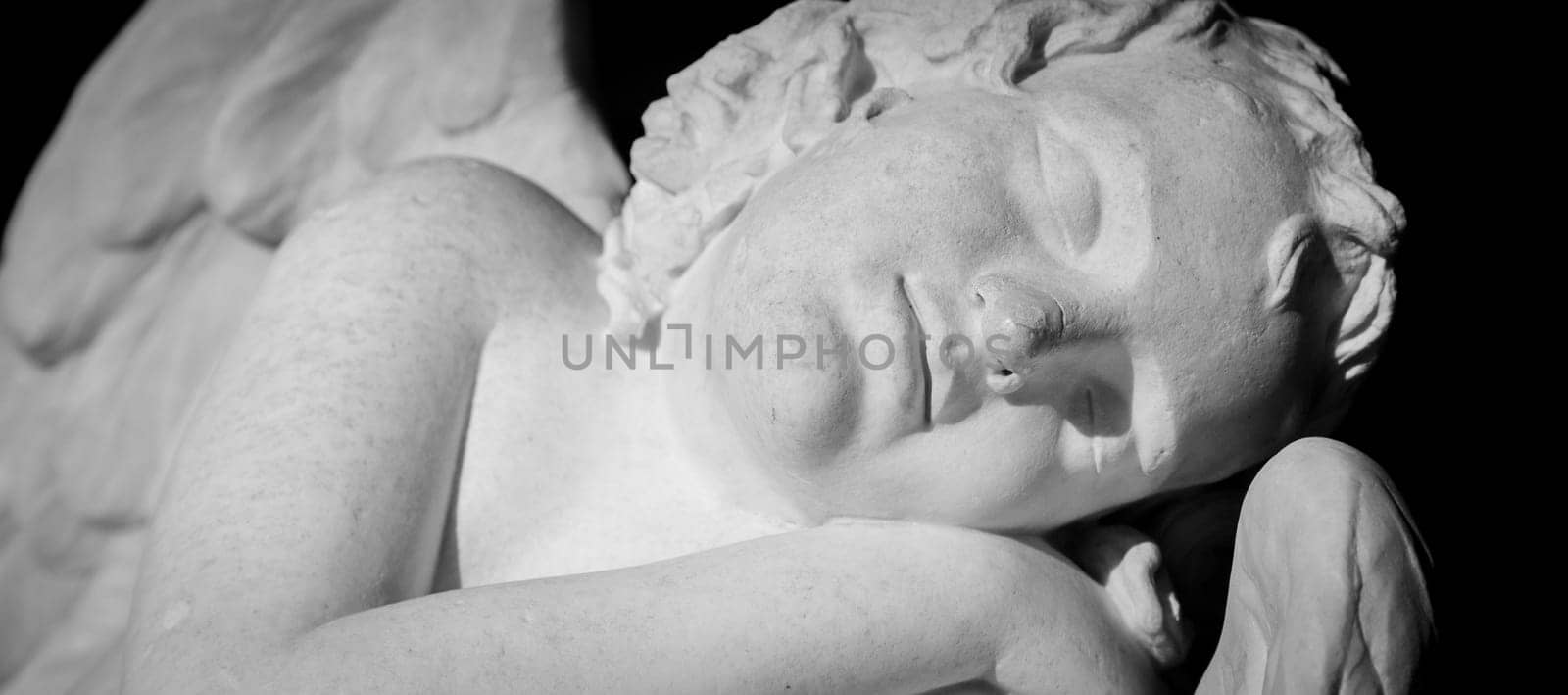 MILAN, ITALY - CIRCA AUGUST 2020: Cute sleeping angel. Statue made in marble, end of 18th century, unknown sculptor. Concept for sleep, innocence and newborrn.