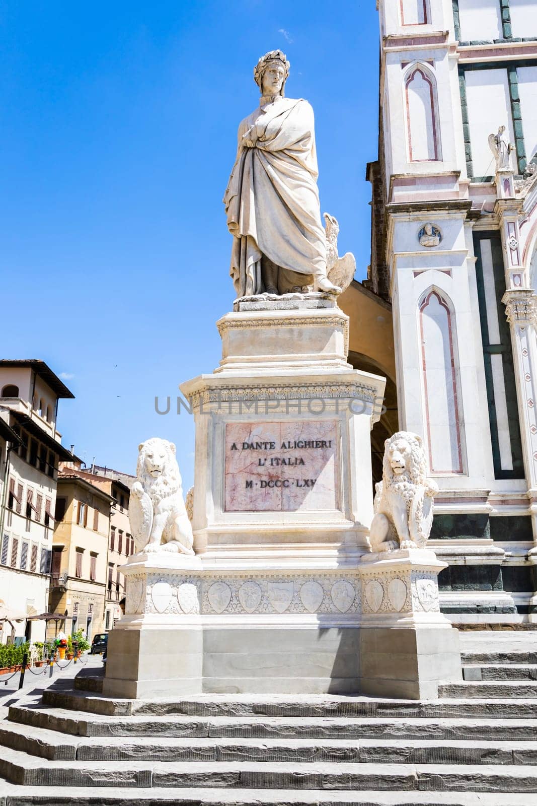 Dante Alighieri statue in Florence, Tuscany region, Italy, with an amazing blue sky background.
