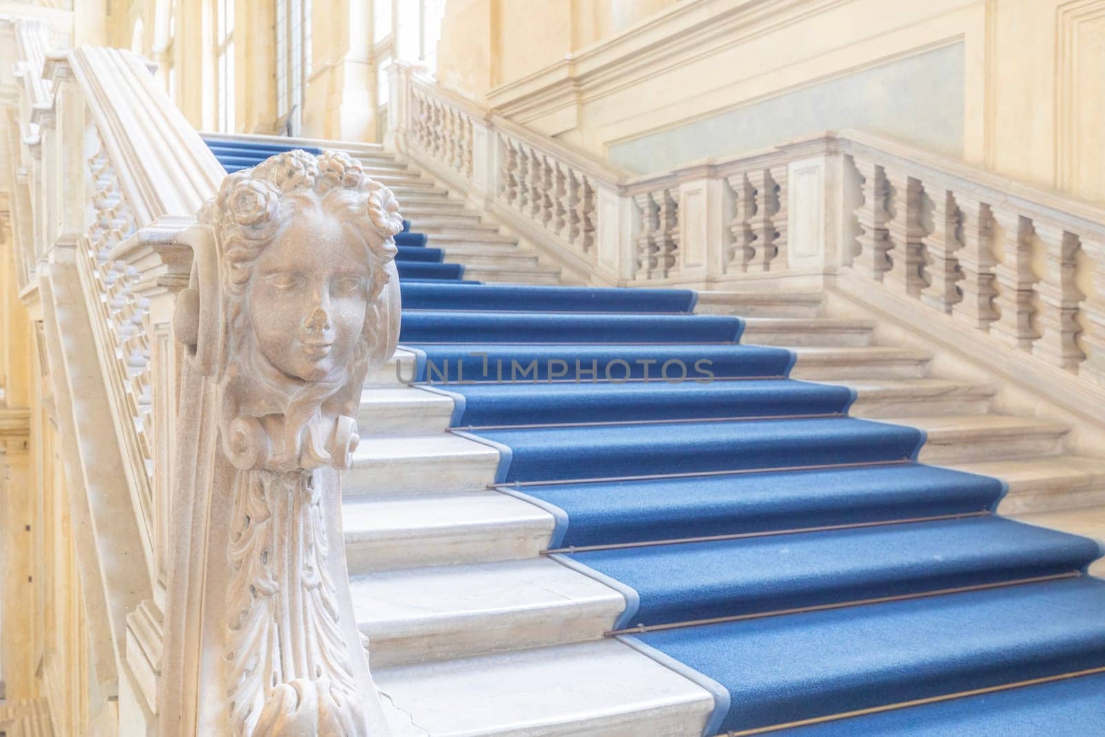TURIN, ITALY - CIRCA JUNE 2021: The most beautiful Baroque staircase of Europe located in Madama Palace (Palazzo Madama). Interior with luxury marbles, windows and corridors.