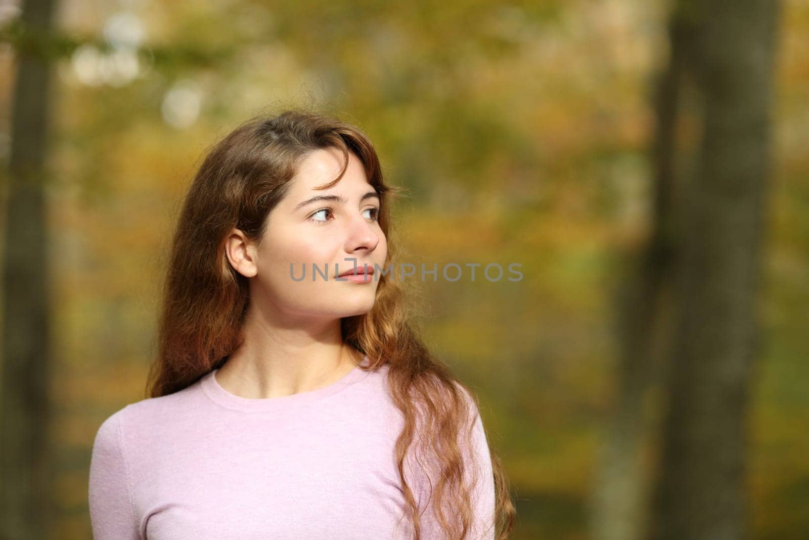 Serious woman looking at side walking in a park