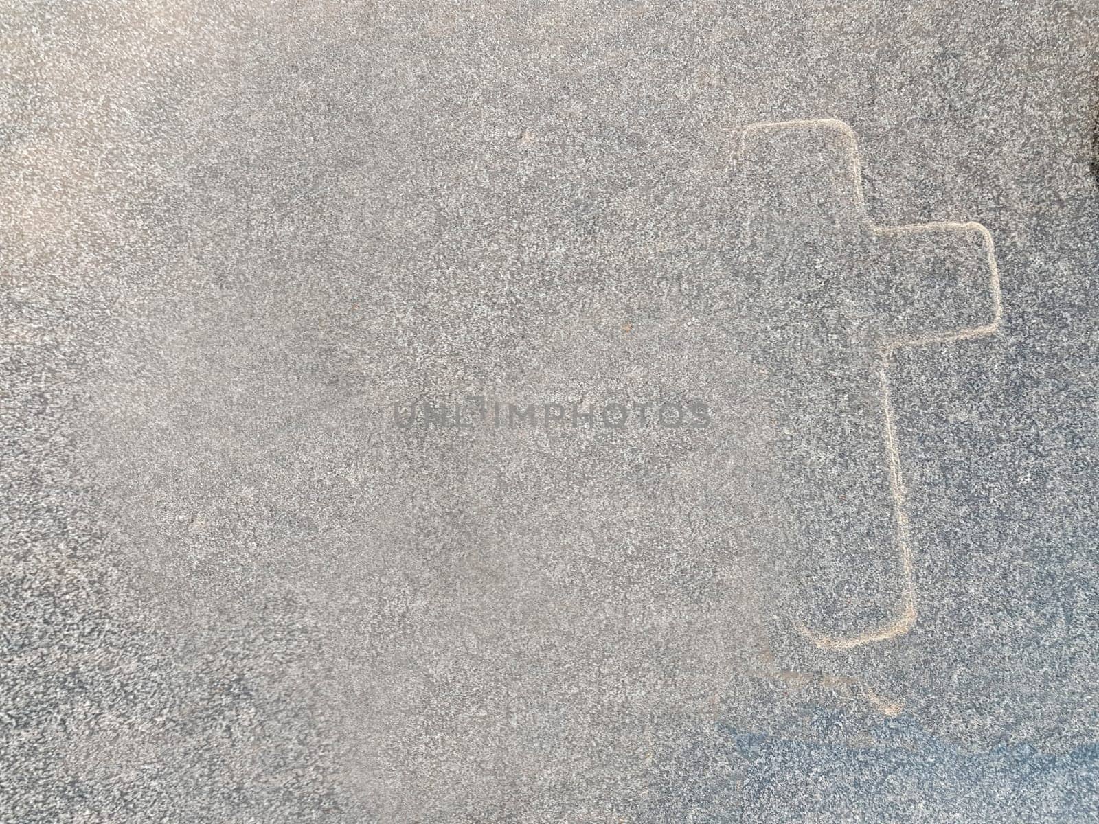 The outline of a cross on marble. A symbol of Christianity on gray marble. The main symbol of Christianity.