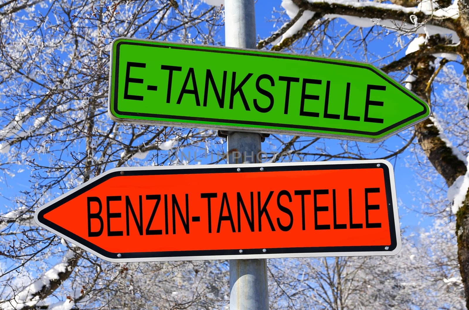 Signs in green for the e-filling station and in red for the gasoline filling station