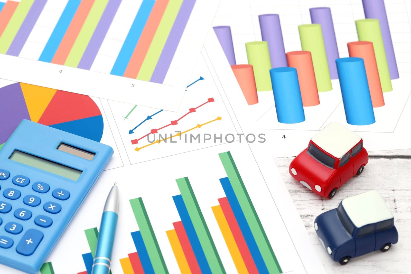 toy car and color chart printed documents, calculator on the table