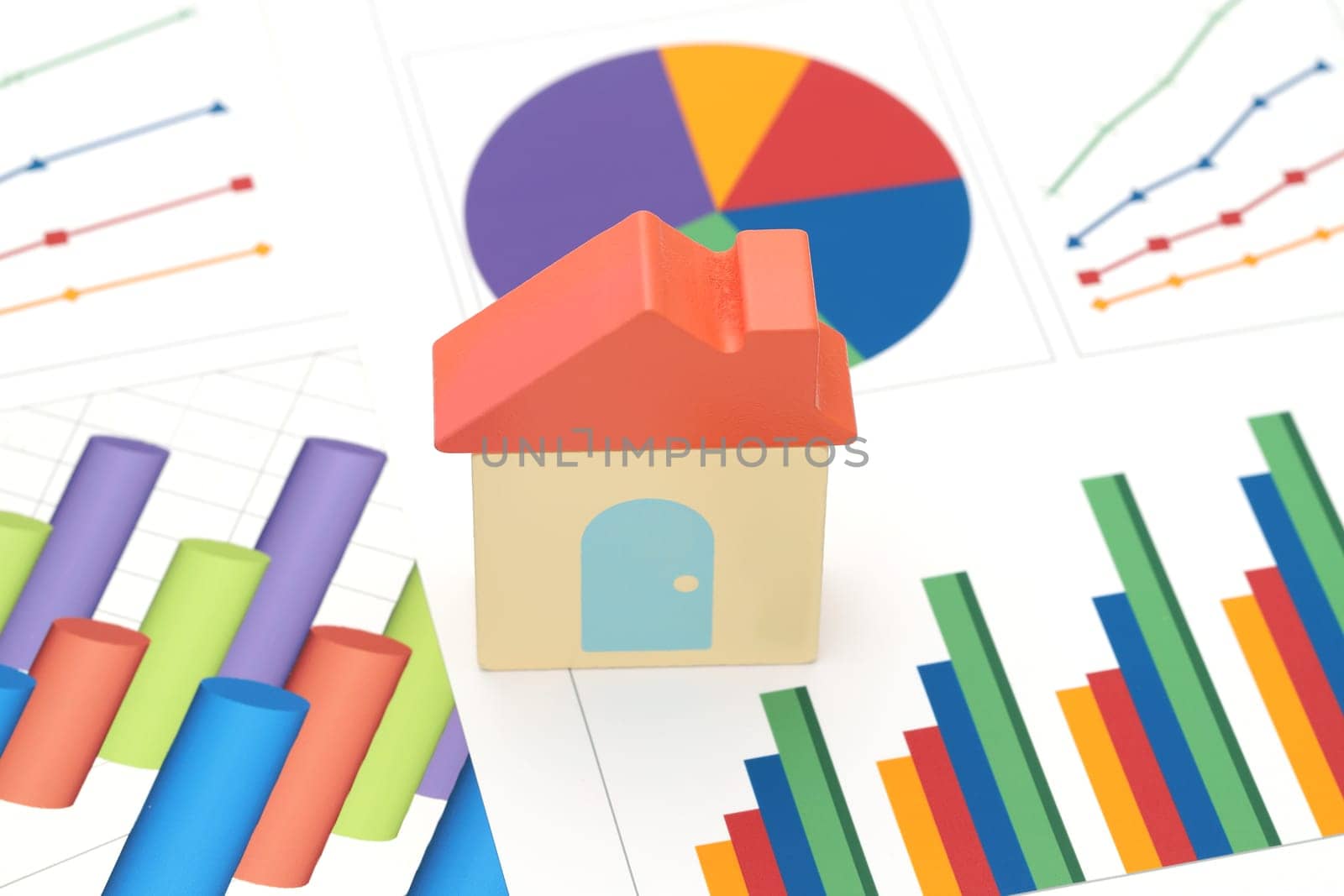 toy house and color chart printed documents on the table