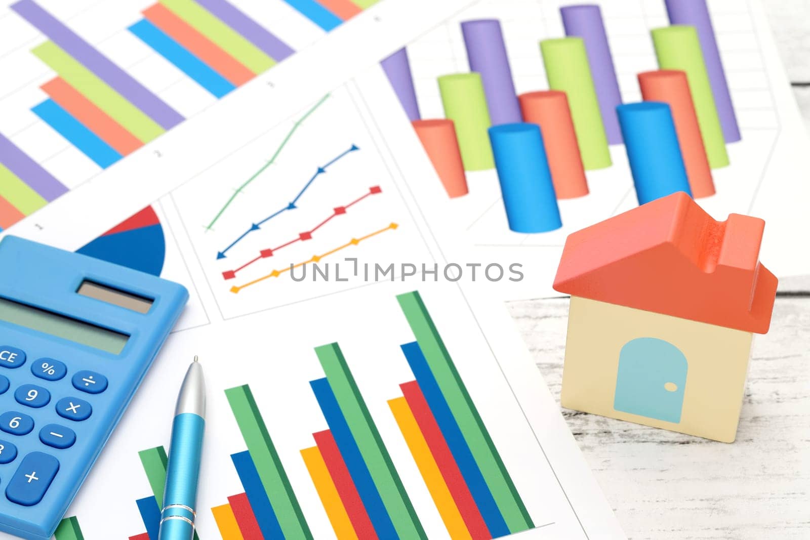 toy house and color chart printed documents on the table
