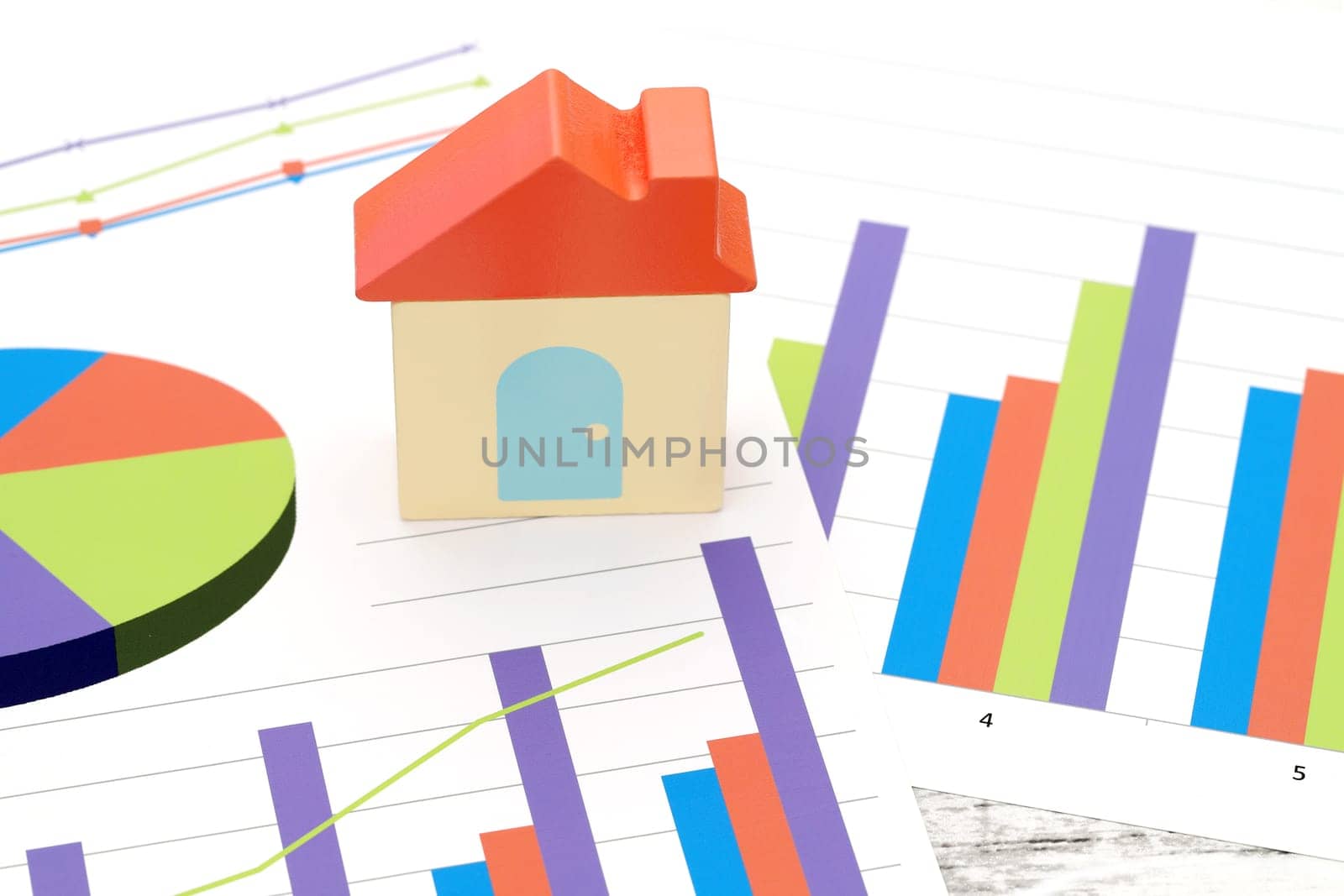 toy house and color chart printed documents on the table