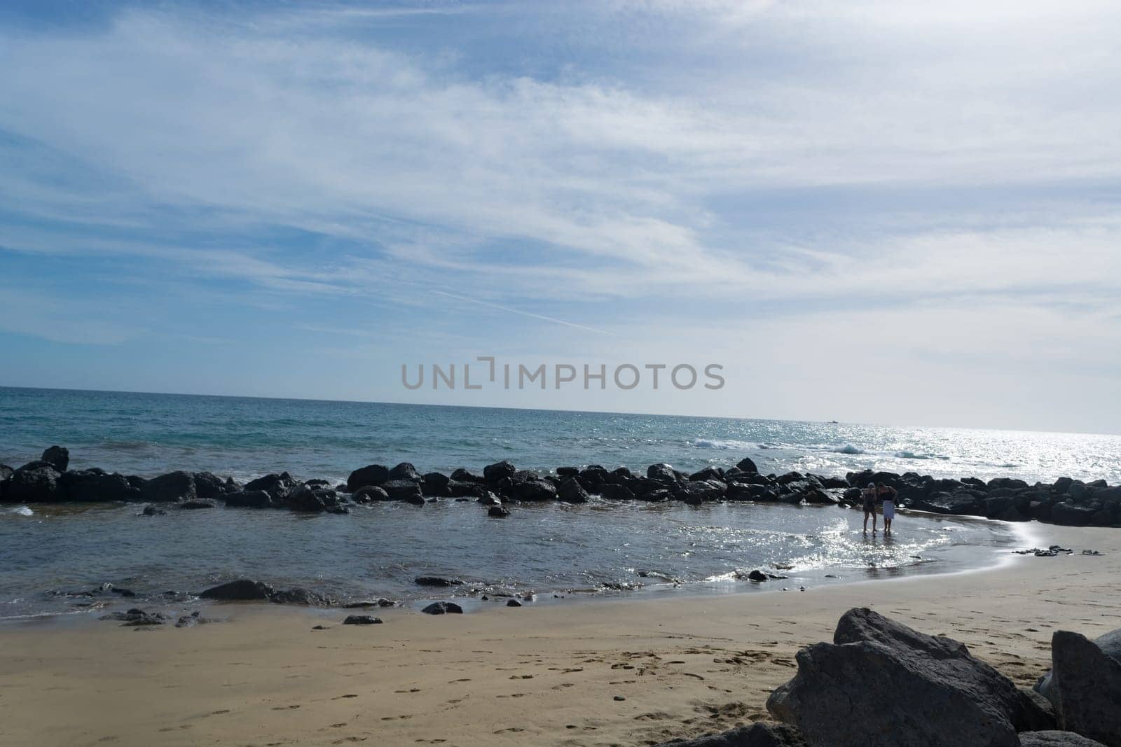 Cran Canaria, Meloneras, Spain - November 13, 2019:.People enjoy the sea view and sit in the sun on the seafront of Meloneras on Gran Canaria, Spain