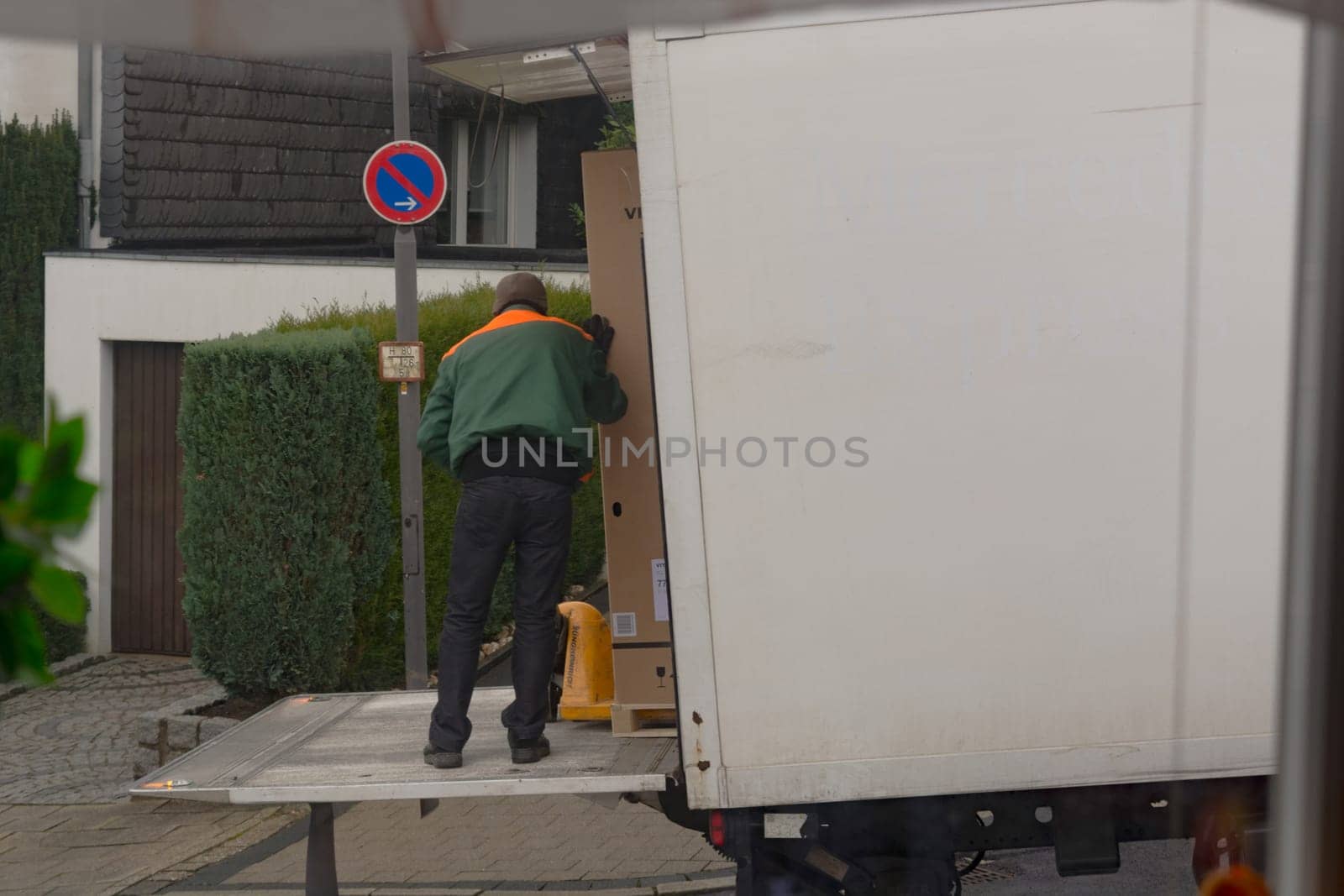 HEILIGENHAUS, NRW - JANUARY 27, 2020:.Logistics and transport of the freight industry, freight shipping, courier transport in the warehouse by truck, stack packaging of packaging boxes that wraps pallet loads in a truck in plastic..