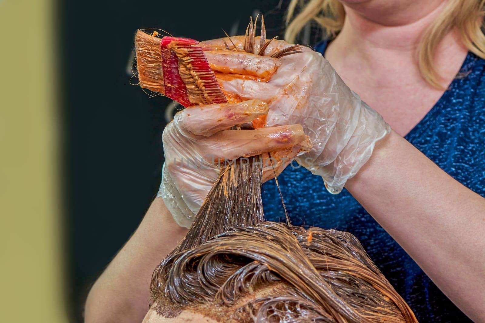 The process of painting women's hair in a barber shop close-up. High quality photo