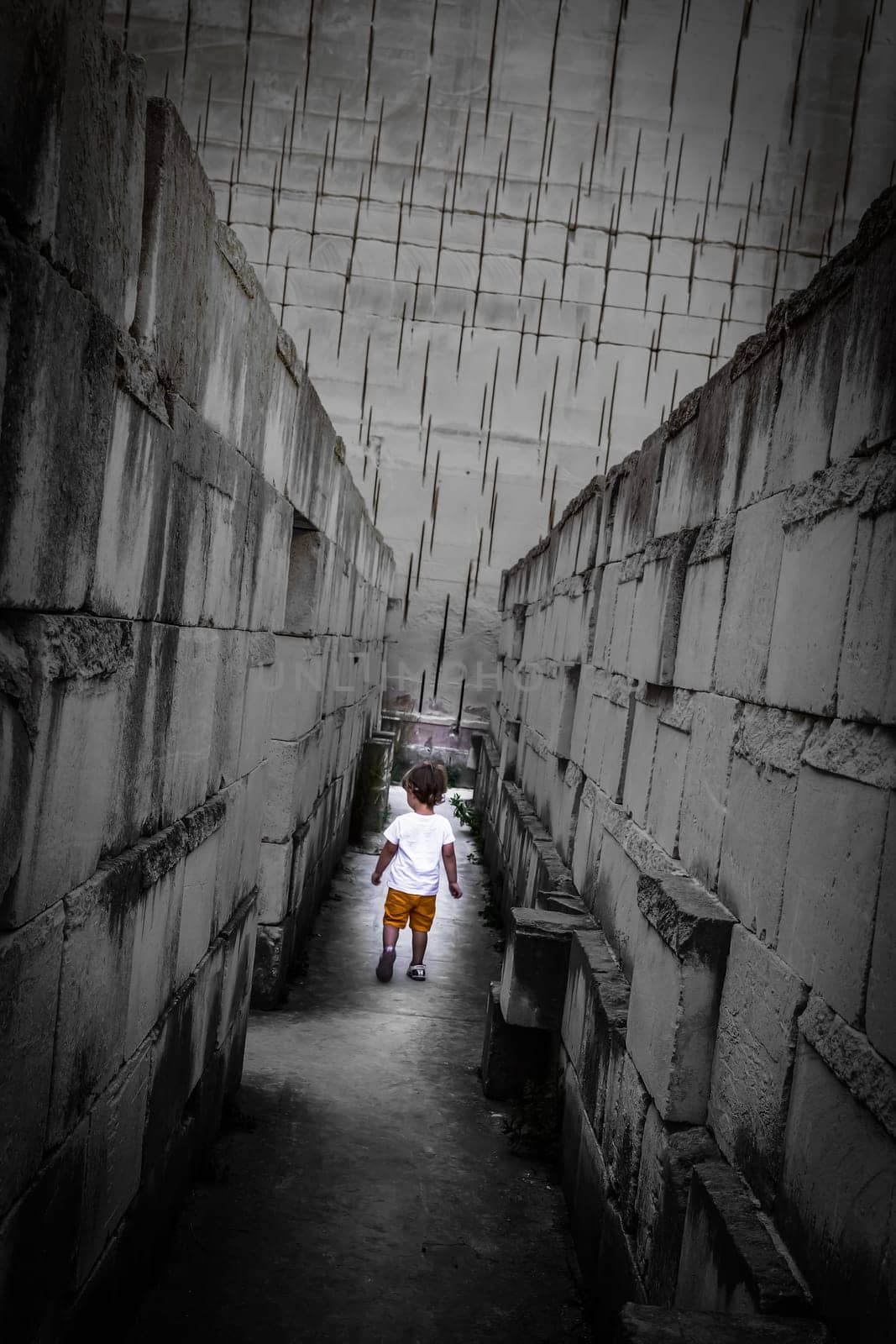 Caucasian young kid walking with labyrinth perspective. Conceptual image for dangerous situation during childhood.