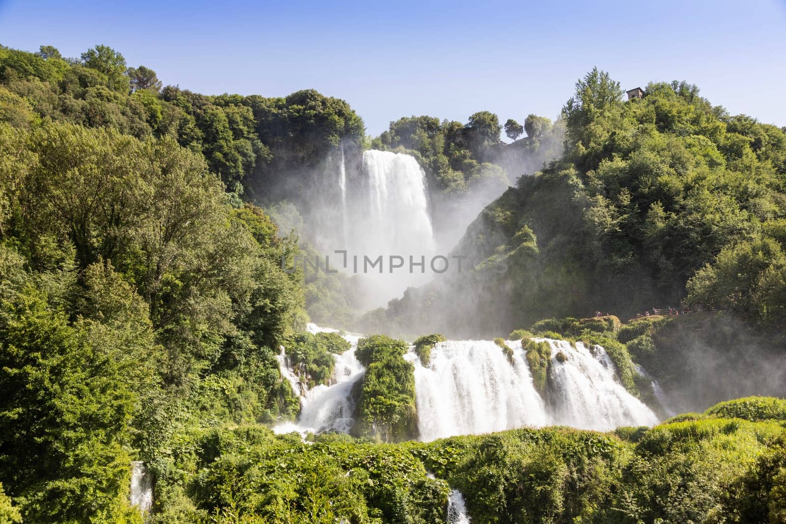 Marmore waterfall in Umbria region, Italy. Amazing cascade splashing into nature with trees and rocks.
