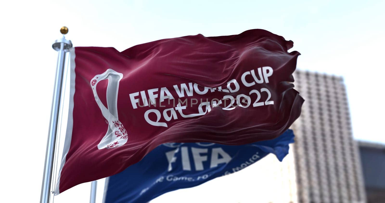 Doha, Qatar, January 2022: Flags with FIFA and Qatar 2022 World Cup logo waving in the wind. The event is scheduled in Qatar from 21 November to 18 December 2022