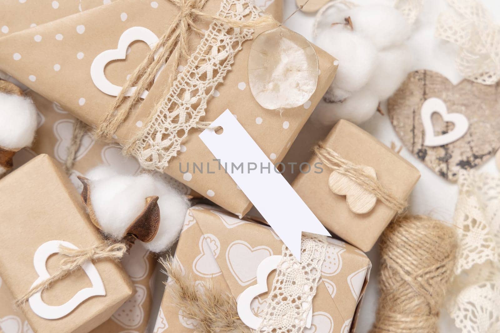 Valentines present with gift tag, heart and pampas grass close up. Spring scene with blank label. Rustic, cottage chic or bohemian mockup, copy space