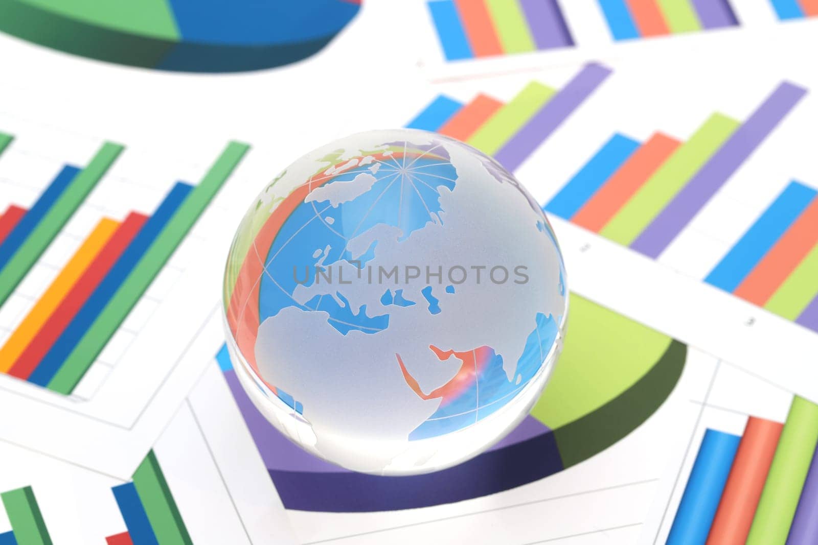 Glass globe of Europe and Africa with graph printed documents