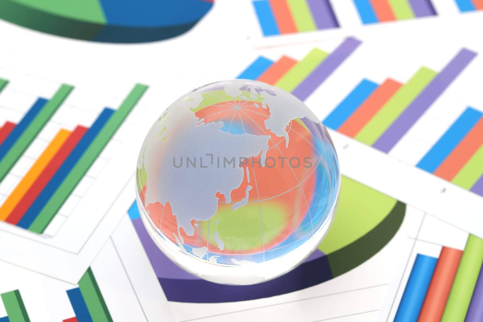 Glass globe of Japan and China with graph printed documents