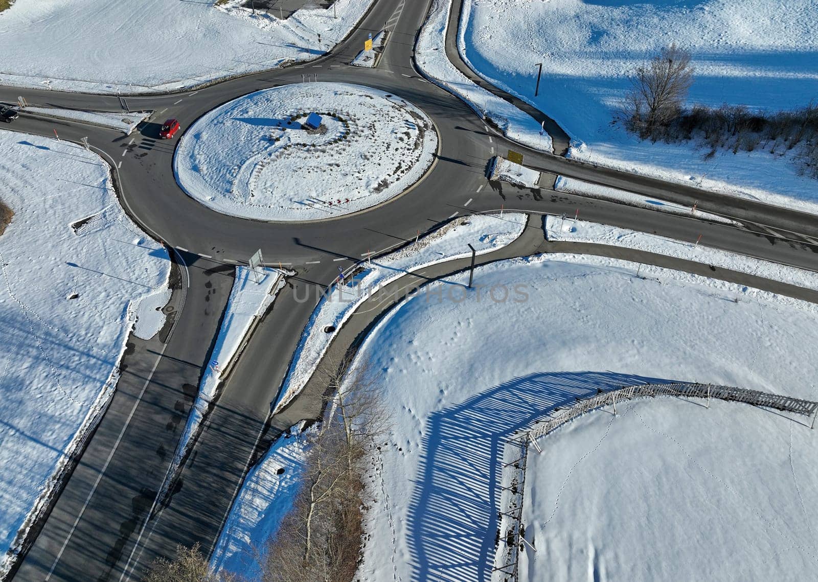 Aerial drone shot of a traffic circle in winter