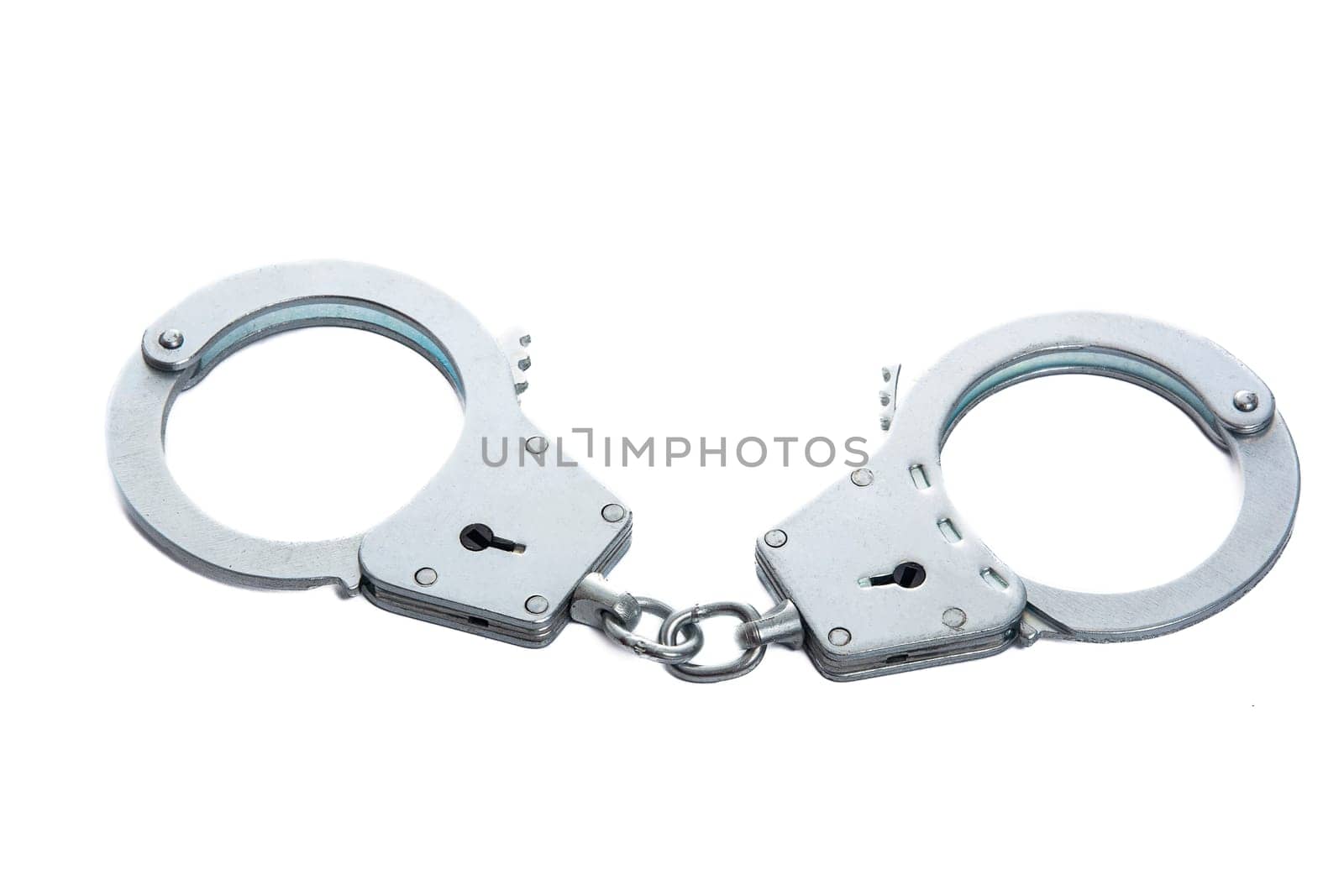 Metal handcuffs on a white isolated background. High quality photo