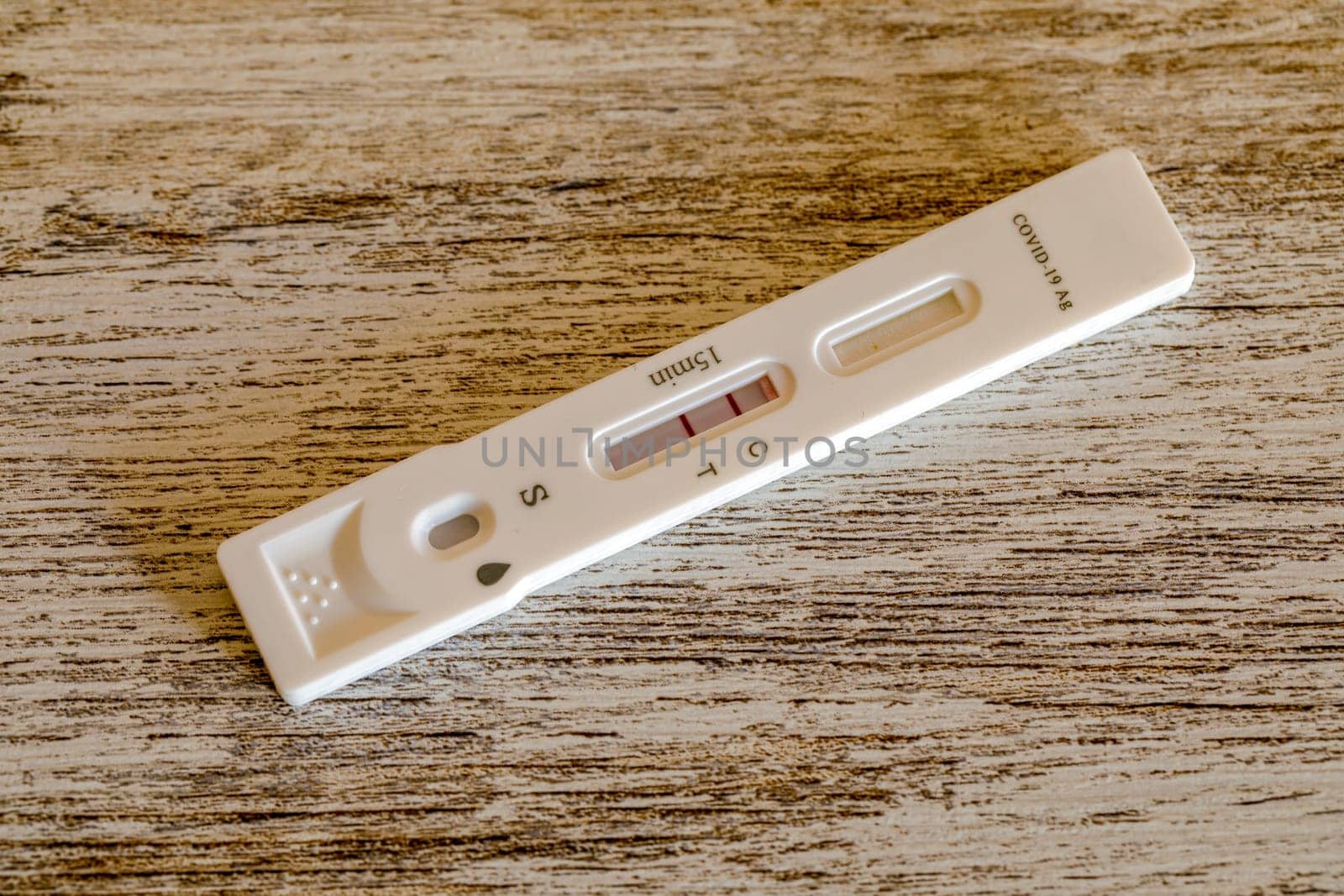 Covid-19 antigen test kit positive, Tested for Covid-19 with a nasal swab. Rapid Antigen Test during Coronavirus Pandemic