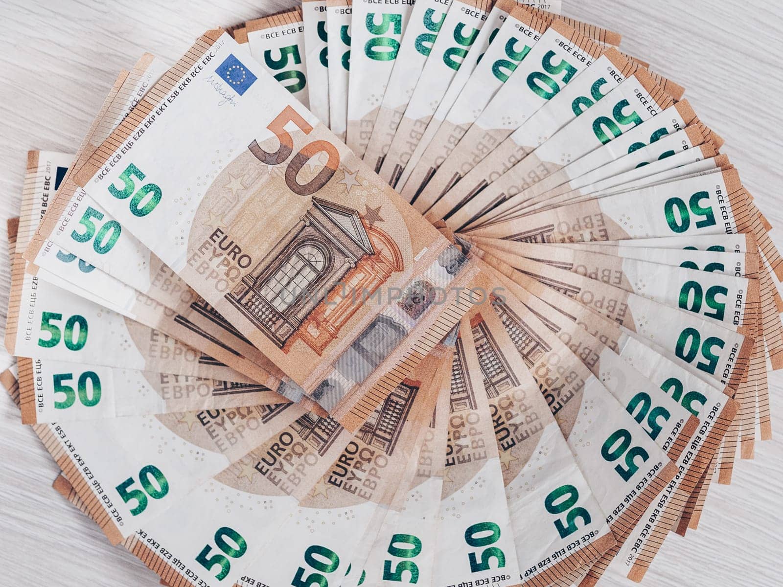 Pile of 50 euro notes, business background.