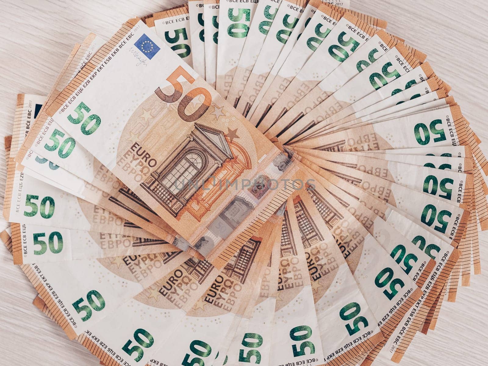 Pile of 50 euro notes, business background.