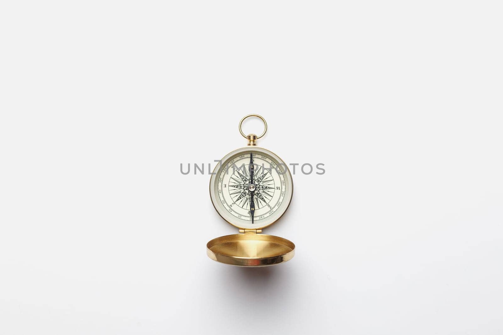 Golden compass on white background concept - direction, top view.