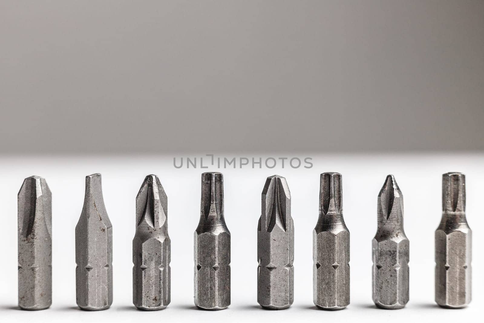 Close-up of a screwdriver nozzles standing in row like soldiers. Duty concept