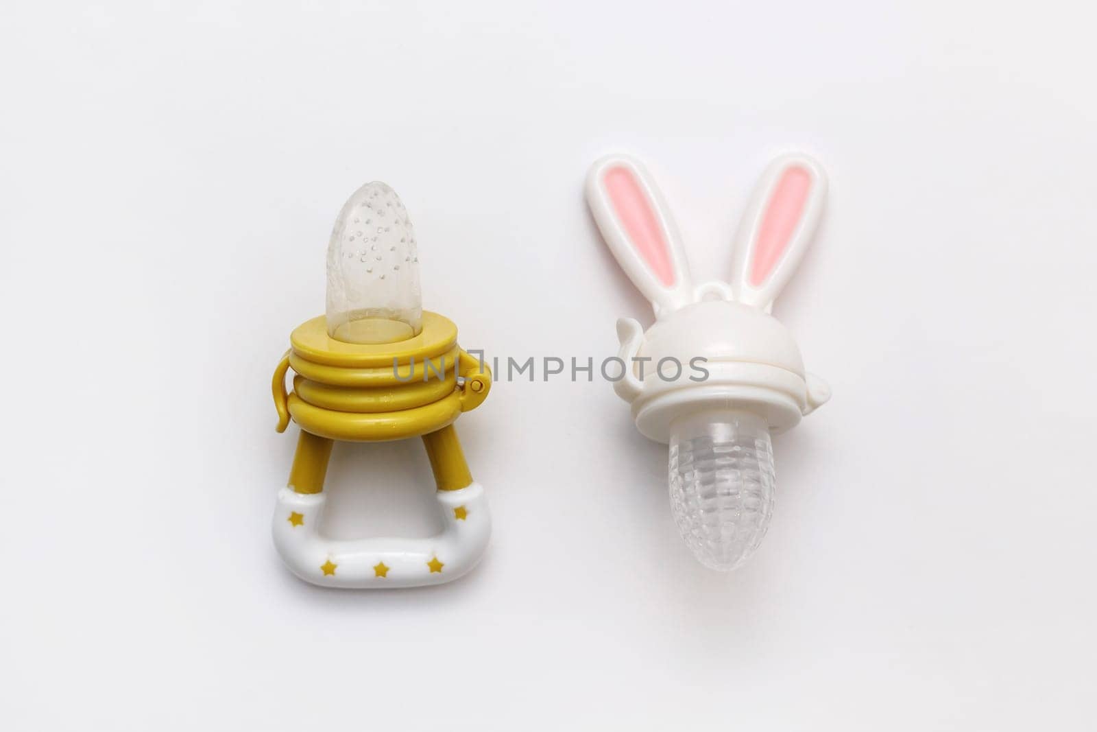 Two baby's nibblers isolated on white background. Flat lay