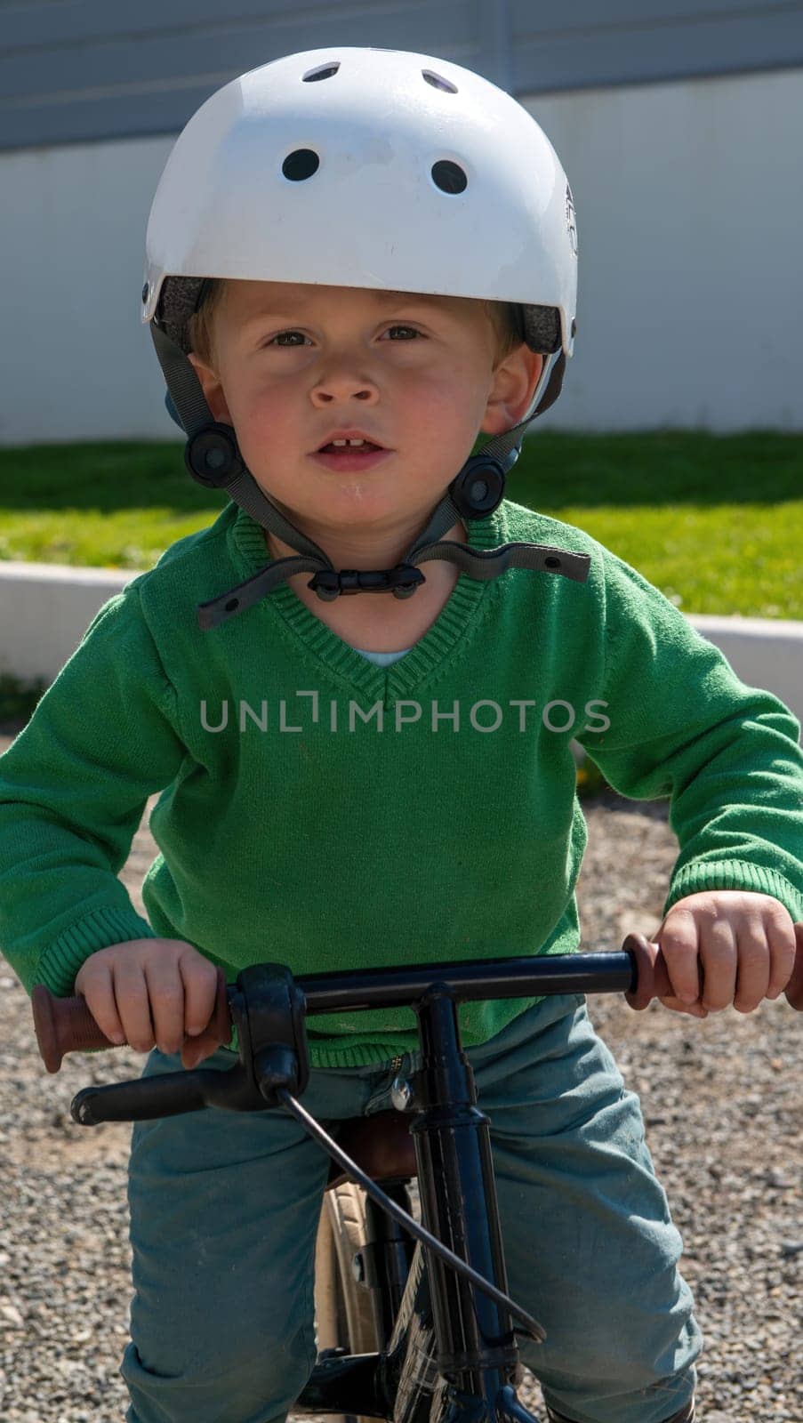 Cheerful little boy riding a bicycle