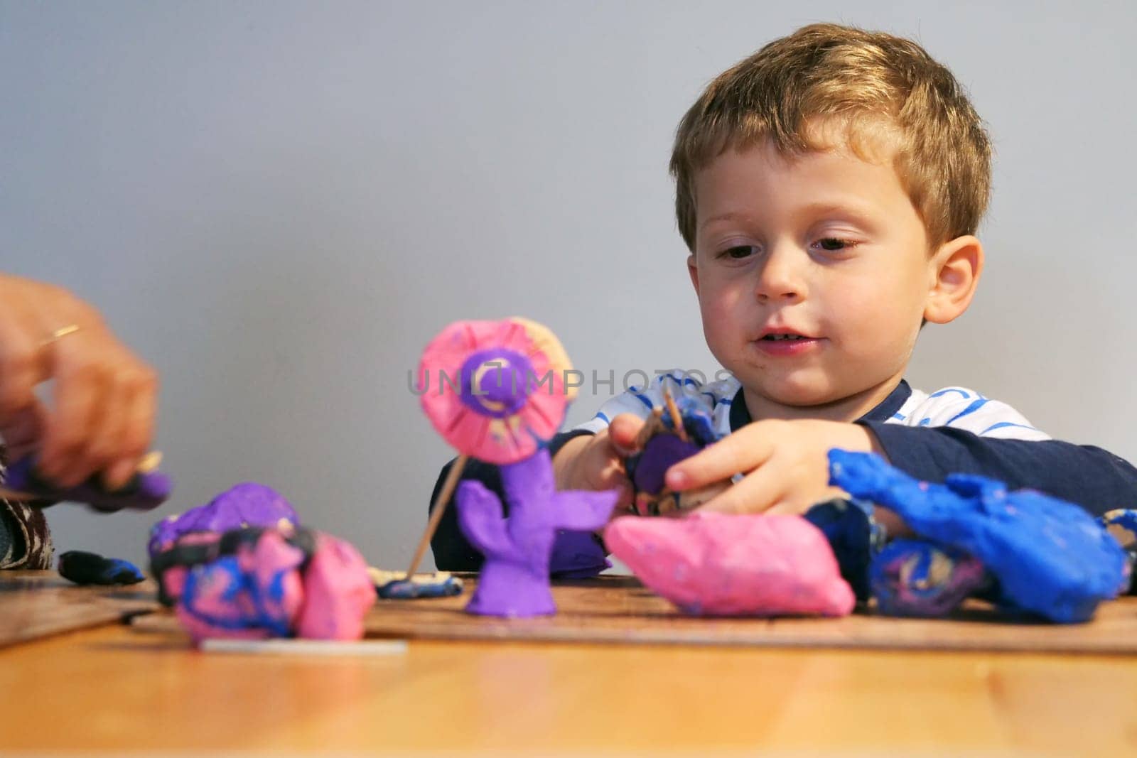 adorable child playing with plasticine