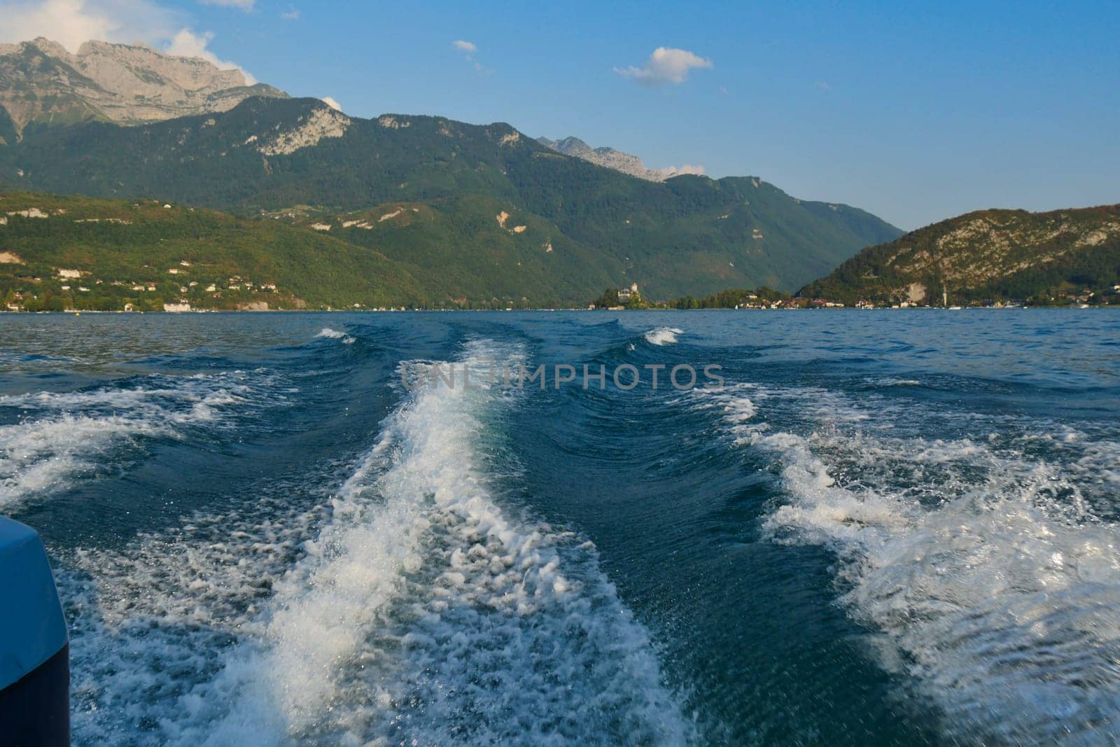 a boat wake on the blue lake of Annecy, France